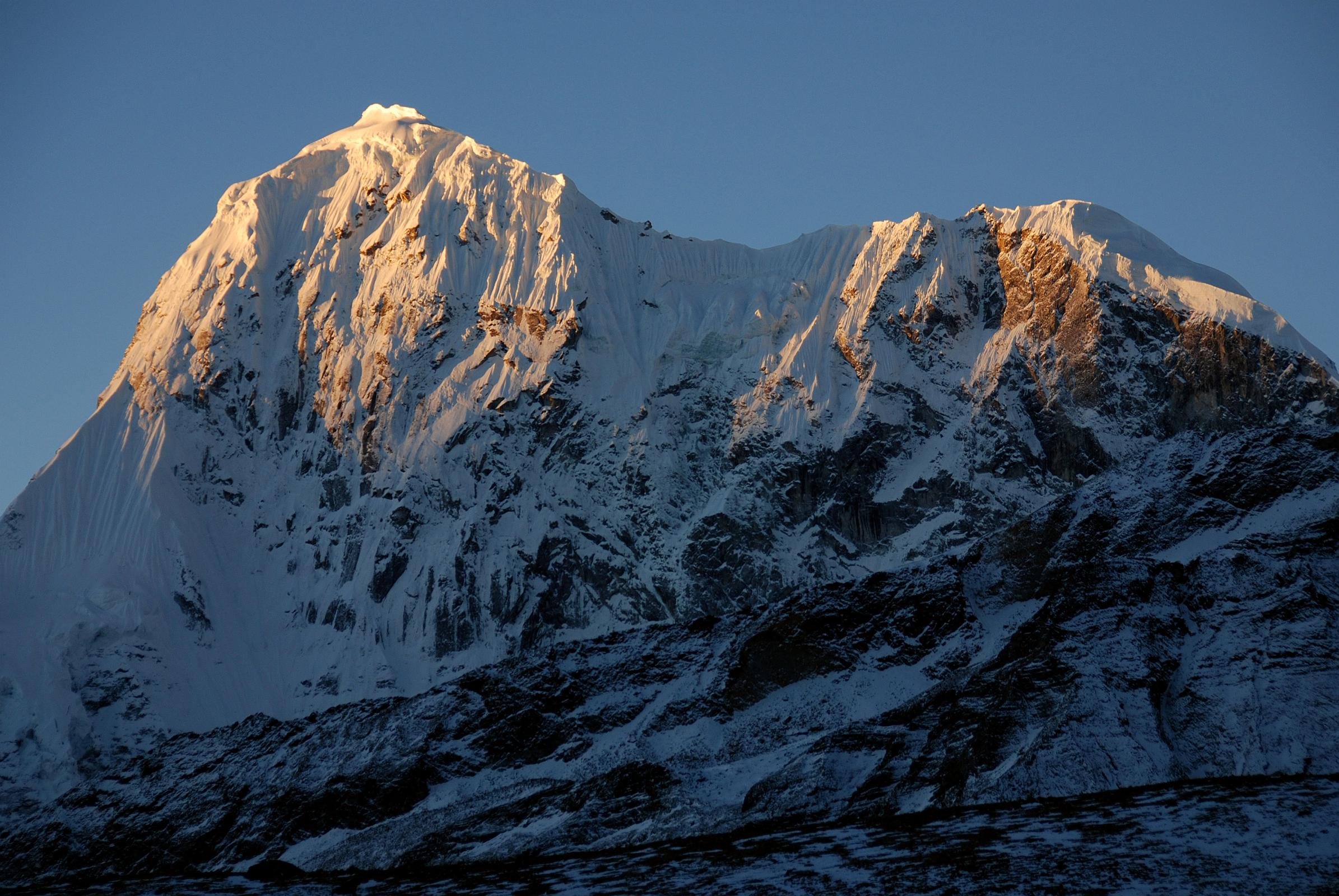 25 Phurbi Chyachu North Face Sunrise From Valley junction To Kong Tso Above Drakpochen The first rays of sunrise silhouette the north face of Phurbi Chyachu (6637m) from the valley junction to Kong Tso above Drakpochen.